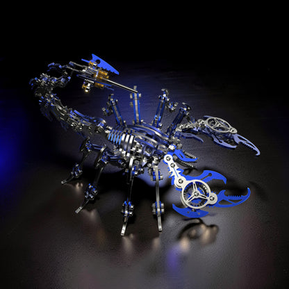 The Curious Mind Mechanical Scorpion 3D metal model kit with silver and blue accents. Intricate gears and metallic pieces form a realistic scorpion sculpture.