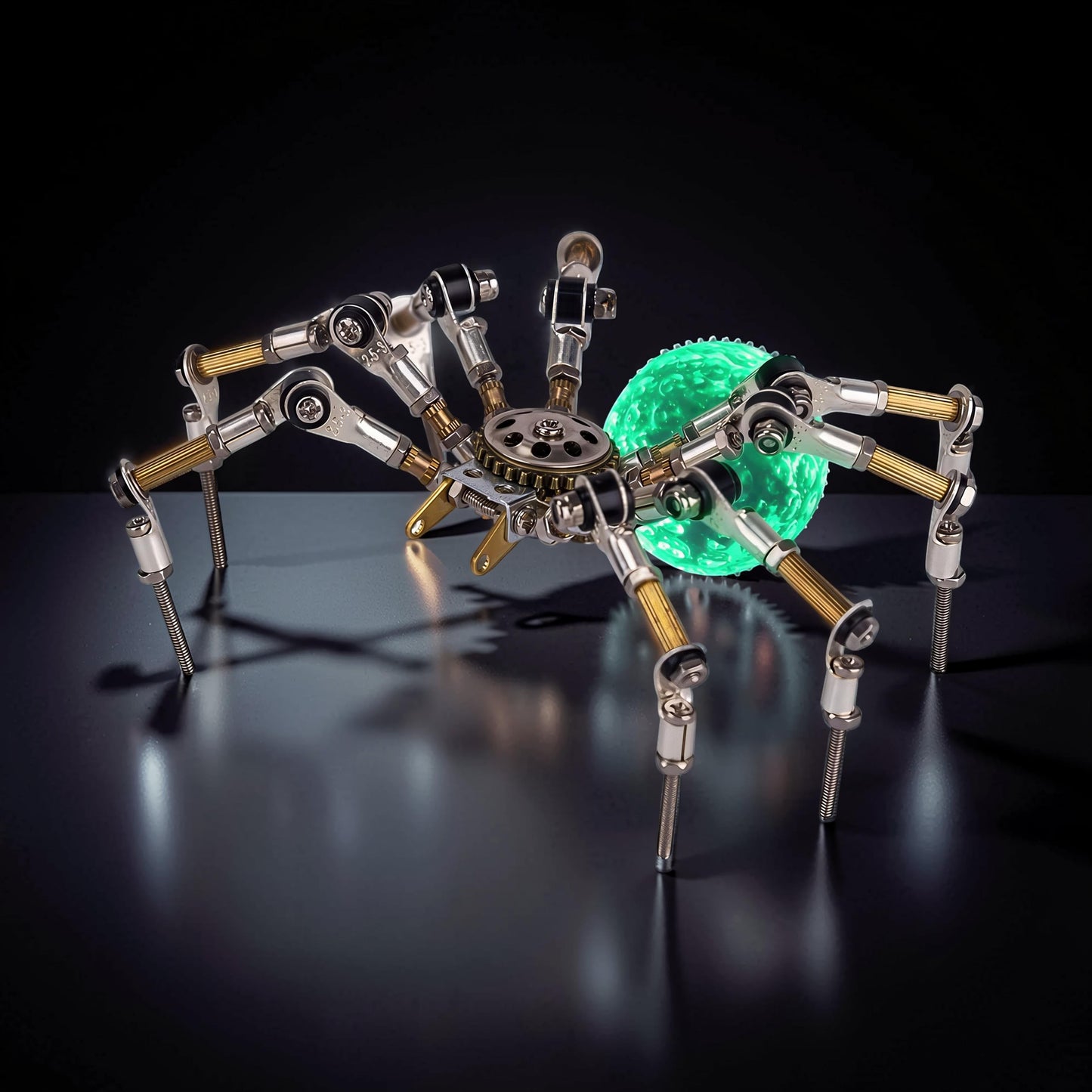 The Curious Mind Style G mechanical spider DIY kit, made of metal with a glowing green orb abdomen.