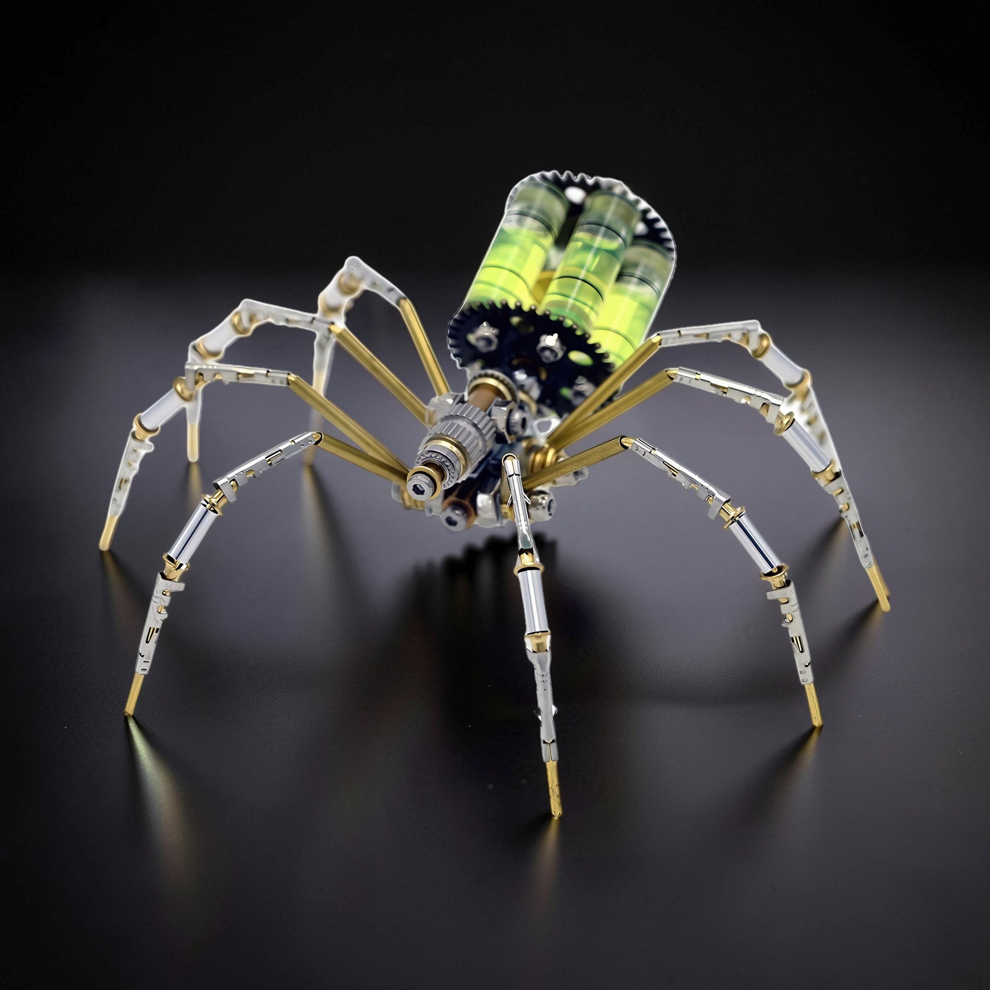 The Curious Mind mechanical spider DIY kit, a metal model with silver, gold, and green accents, featuring intricate gears and transparent tubes.