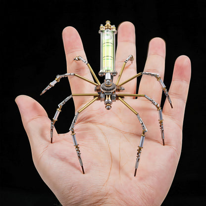 The Curious Mind mechanical spider DIY kit, made of metal, with a level bubble on its back, held in a hand.