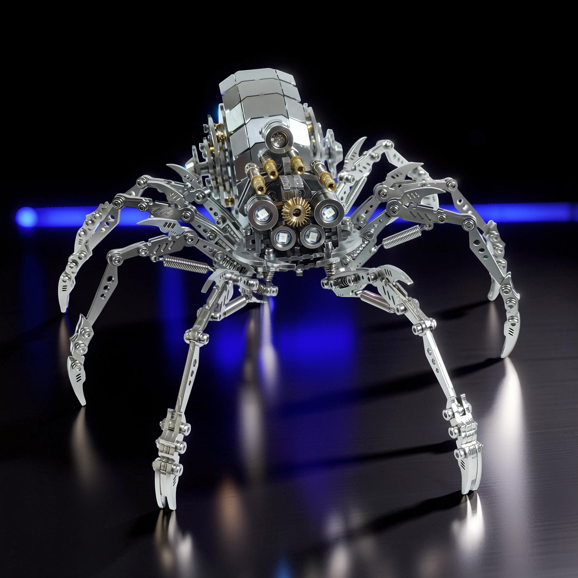 The Curious Mind Mechanical Spider 3D metal model kit with intricate gears and lights. Silver metal construction.