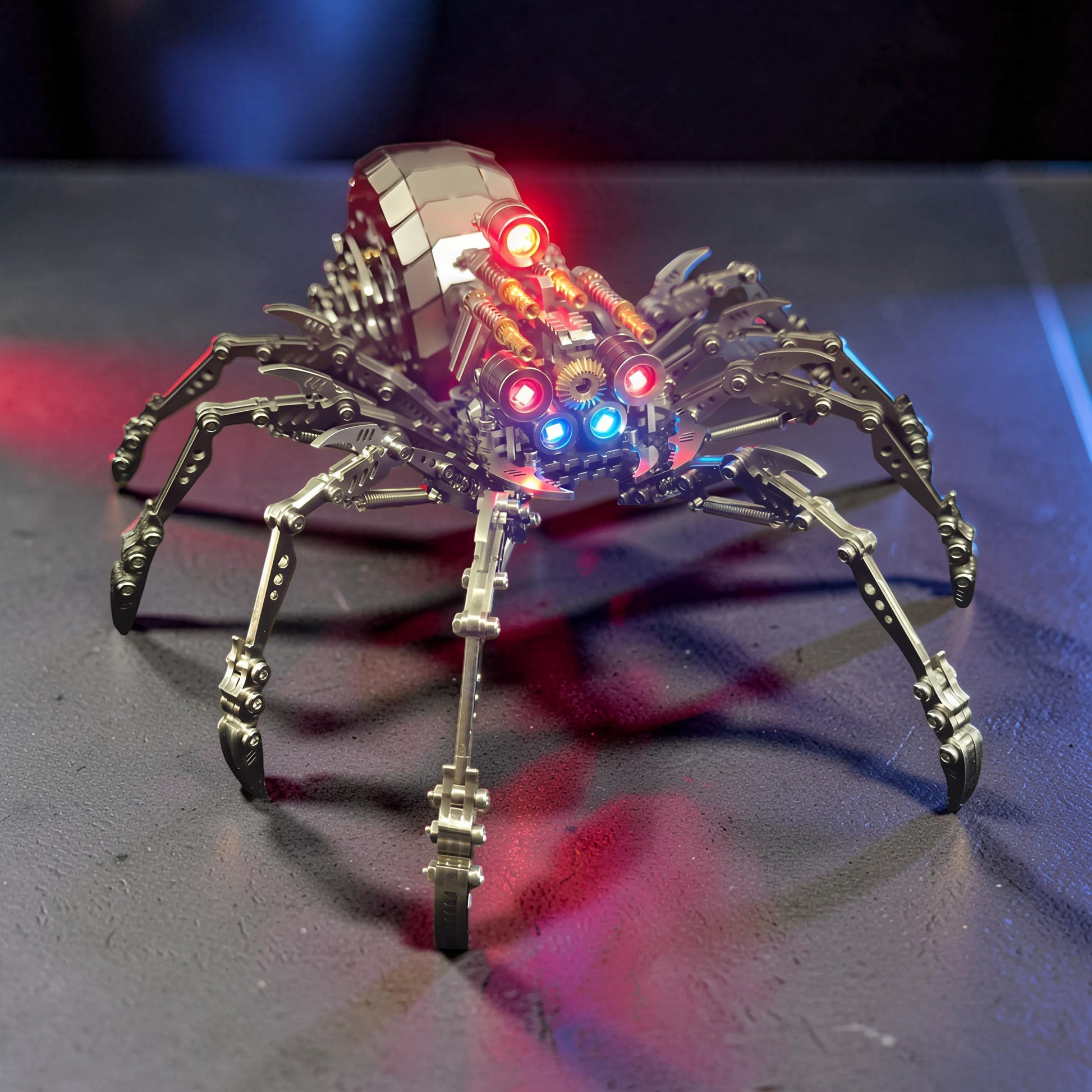 The Curious Mind Mechanical Spider 3D metal model kit with intricate details and red and blue LED lights.