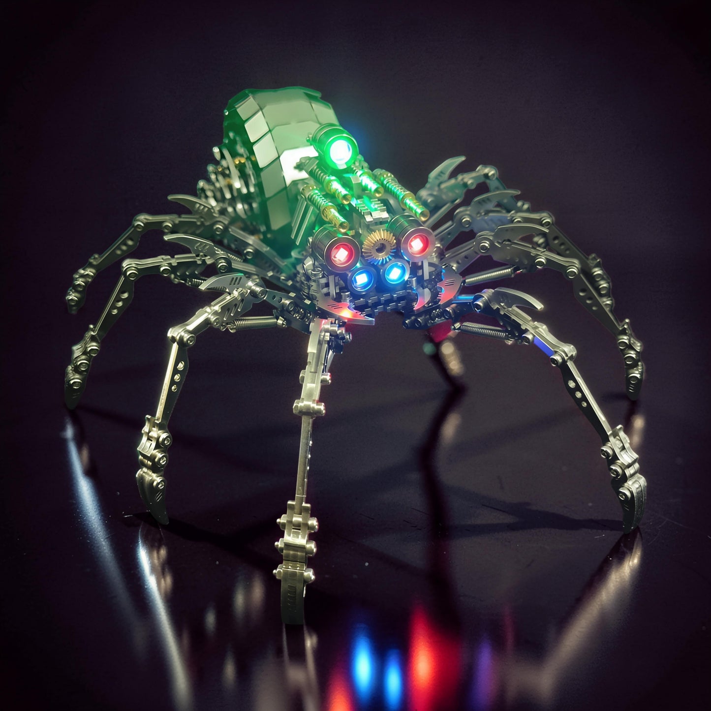 The Curious Mind Mechanical Spider 3D metal model kit with green, red, and blue LED lights. Intricate metal construction with steampunk details.