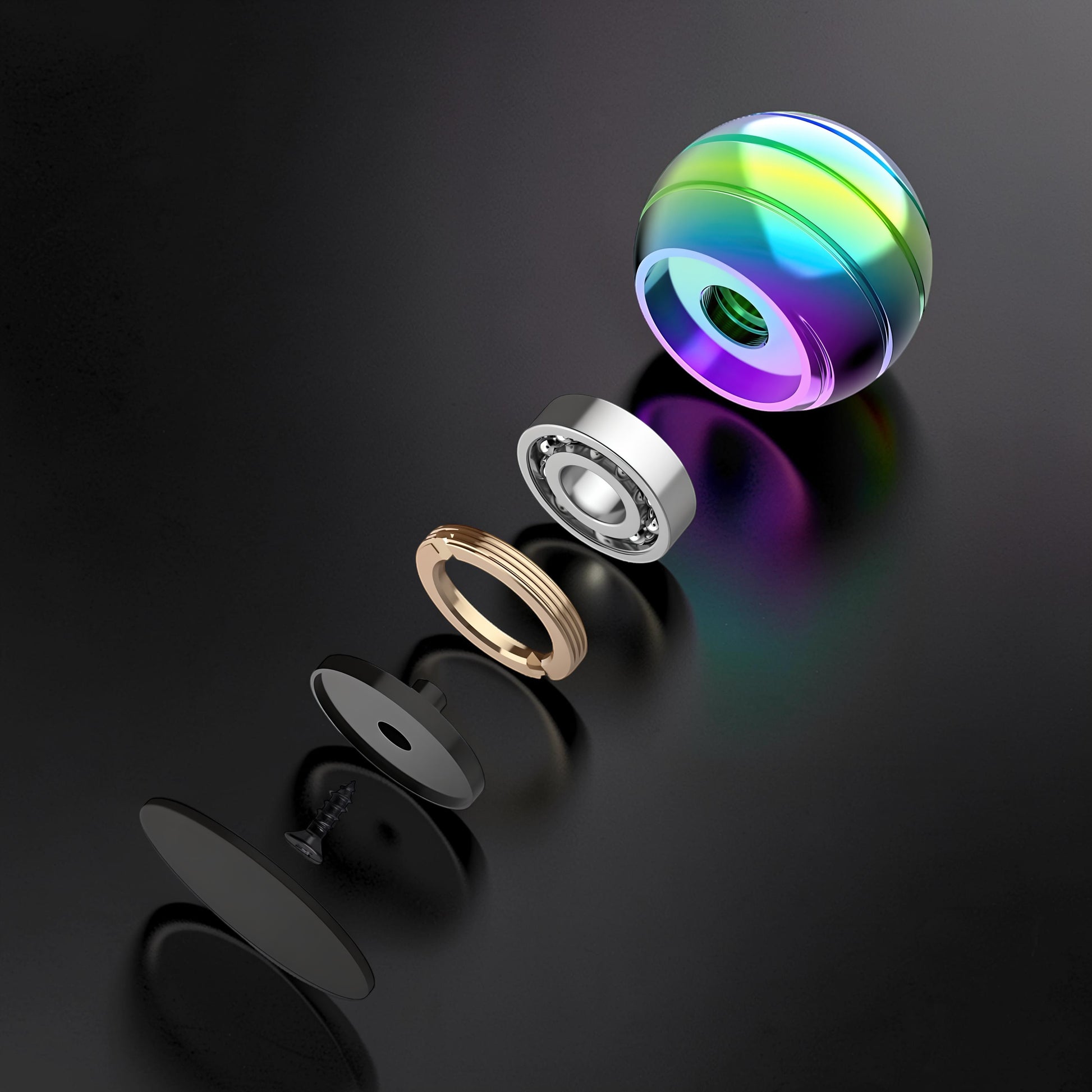 The Curious Mind high-gloss metal desktop stress ball, shown disassembled with rainbow iridescent finish and ball bearing.