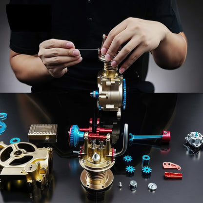 The Curious Mind Mini Single-Cylinder Engine DIY Kit, a metal mechanical model with gold, red, and blue accents, being assembled.
