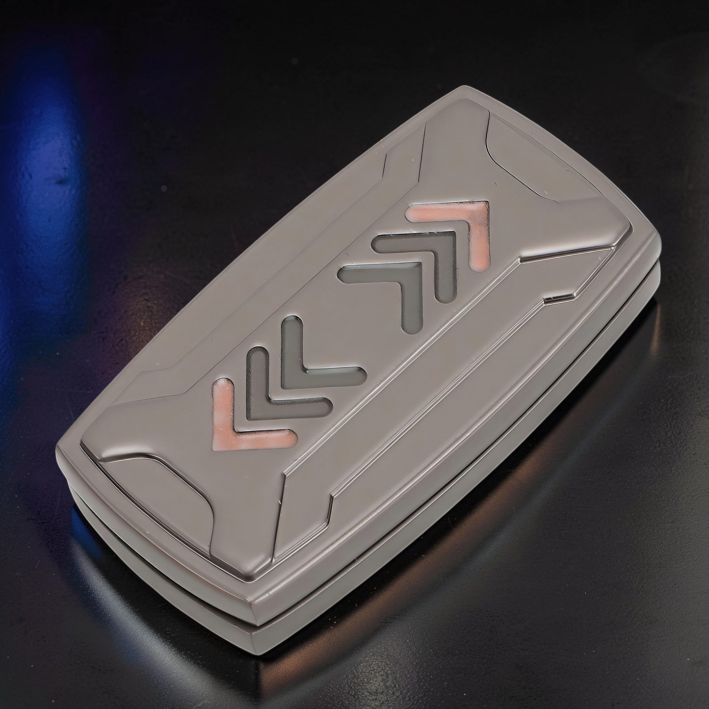 The Curious Mind Arrow Pusher Click Slider fidget toy, a compact metal slider with grey and copper accents, designed for stress relief and focus.