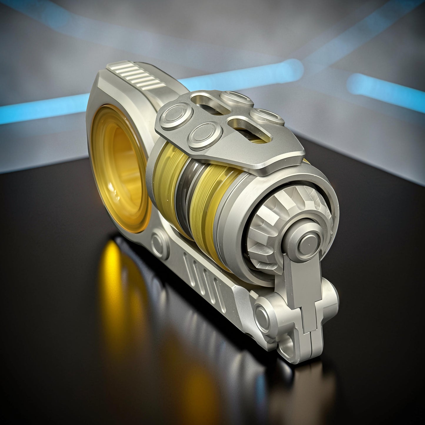 The Curious Mind Fork Ratchet Metal Slider fidget toy with yellow and black internal rings and a silver metallic finish.