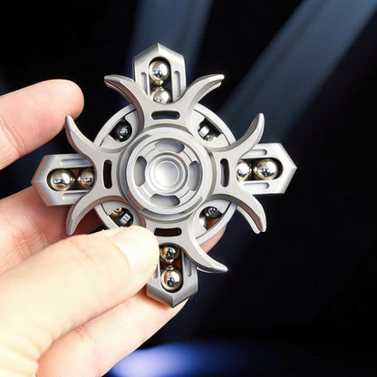 The Curious Mind Oracle Metal EDC Fidget Spinner with a silver finish, featuring a unique starburst design and multiple ball bearings for smooth tactile play.