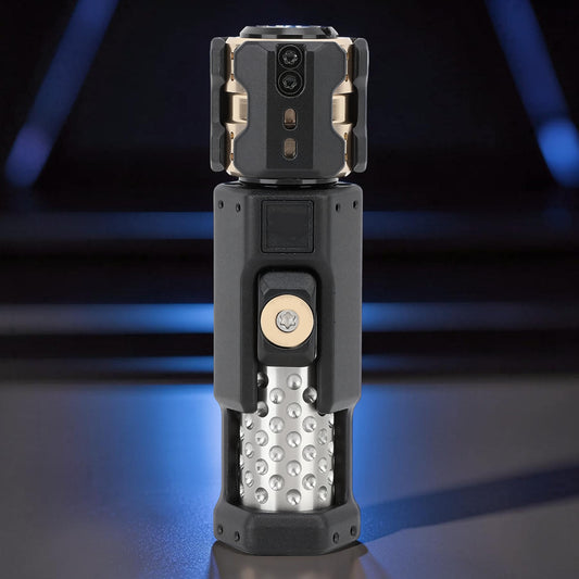 The Curious Mind Musketeers Snap Coin Clicker fidget toy, black metal with gold accents and textured silver cylinder.