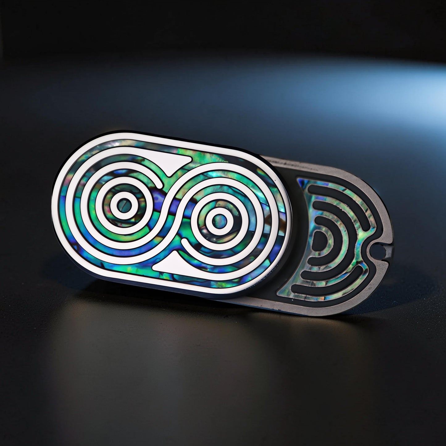 The Curious Mind Fritillary Push Slider fidget toy with iridescent abalone inlay and silver accents.