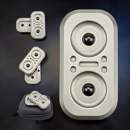 The Curious Mind Owl Push Slider, a compact silver metal fidget toy with two black ball bearings and tactile push buttons. Includes a black carrying case.