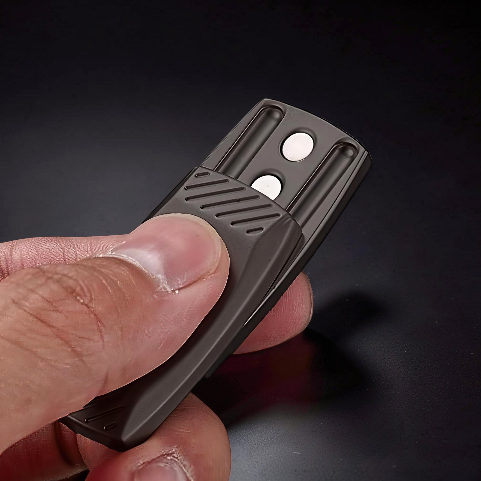 The Curious Mind Fingerprint Pattern Push Slider, a compact dark gray metal fidget toy with textured grip and two white magnetic sliders.