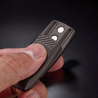 The Curious Mind Fingerprint Pattern Push Slider, a compact dark gray metal fidget toy with textured grip and two white magnetic sliders.
