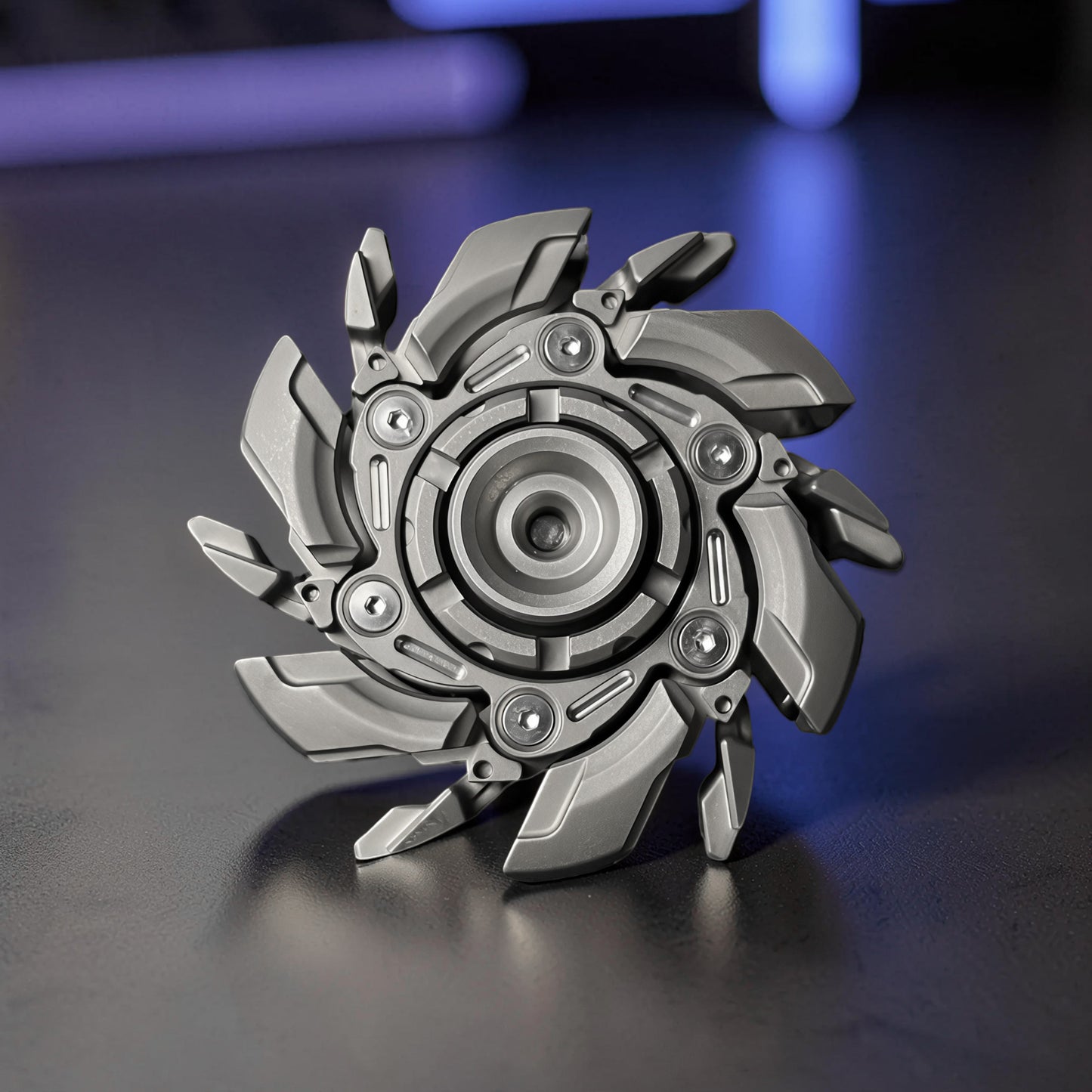 The Curious Mind Open Armour magnetic metal spinner with a futuristic, segmented design in a matte grey finish.