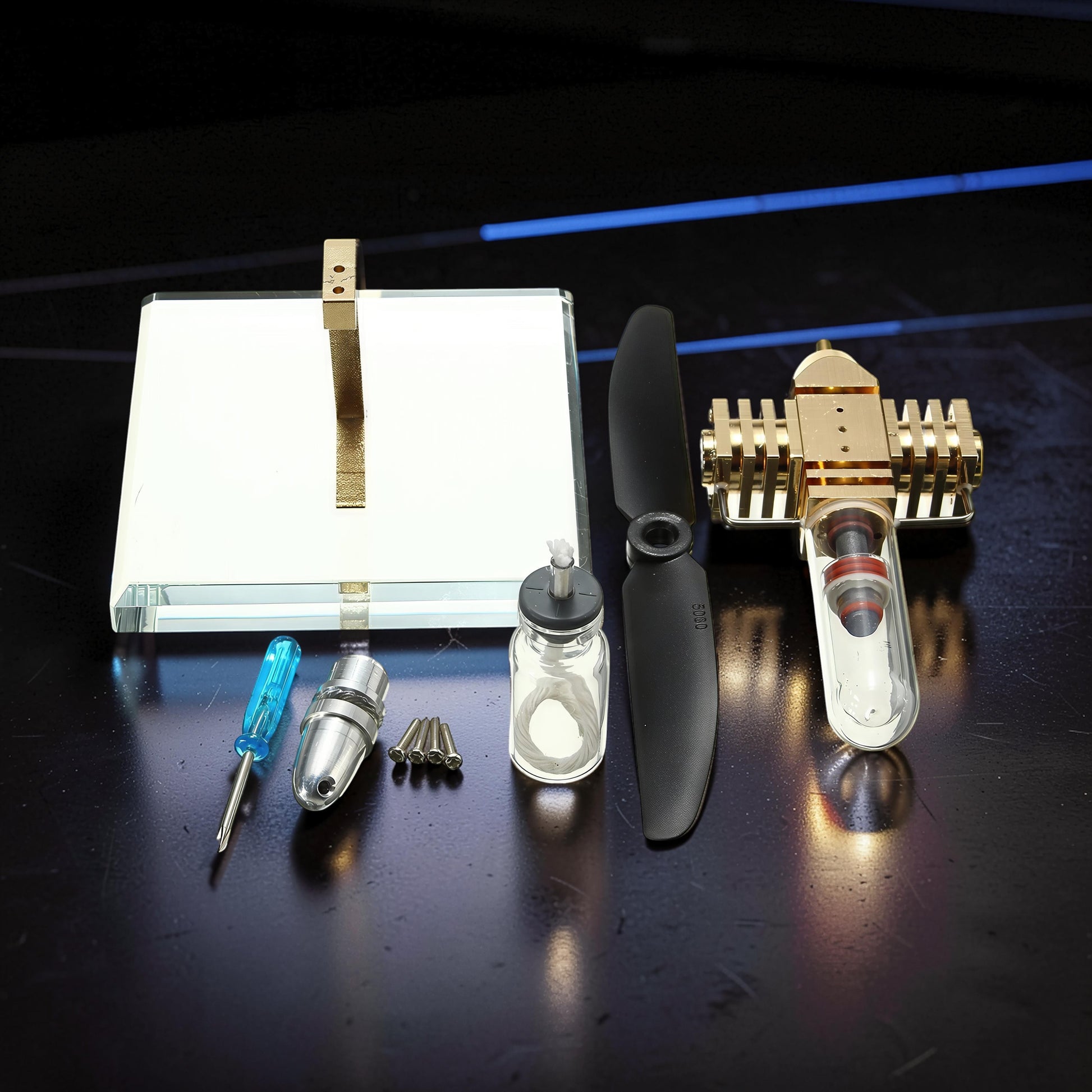 The Curious Mind Mini Aircraft Stirling Engine Display Model, made of metal with a glass cylinder and propeller.