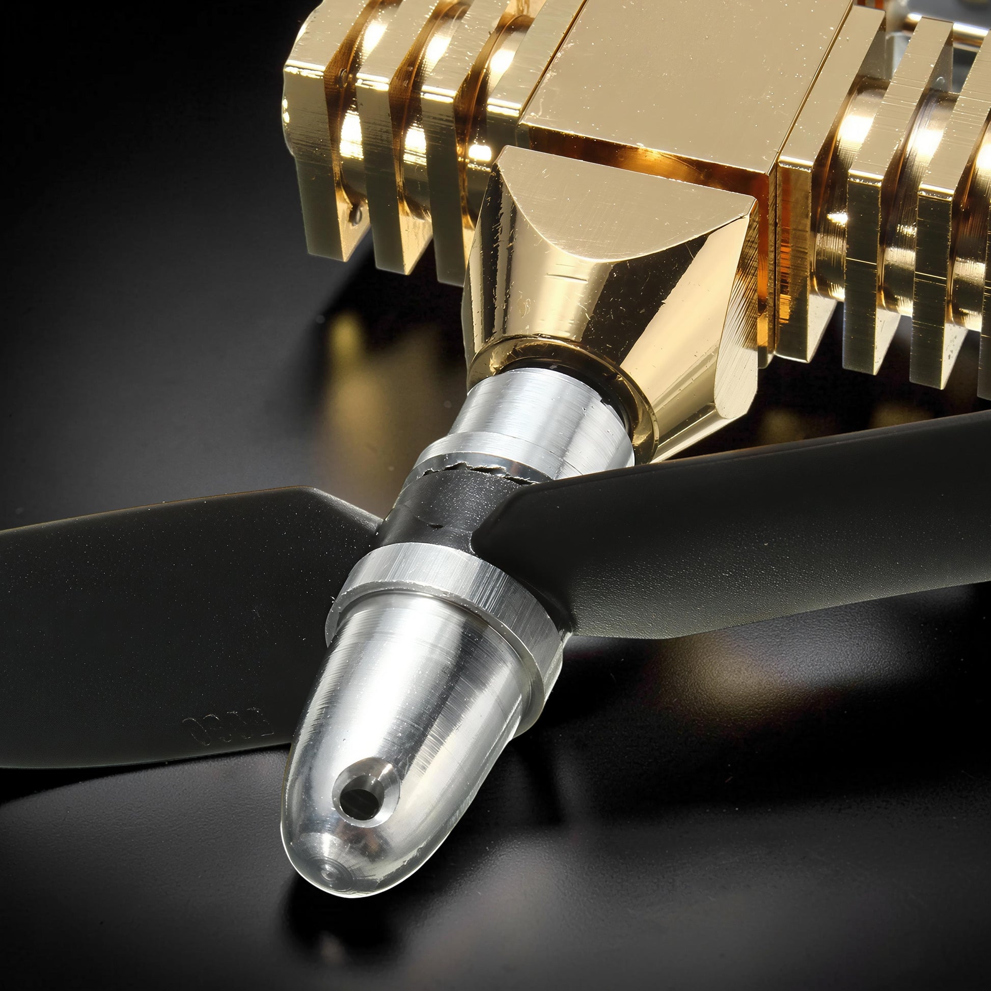 The Curious Mind Mini Aircraft Stirling Engine Display Model, gold metal engine with black propeller, desktop mechanical model.