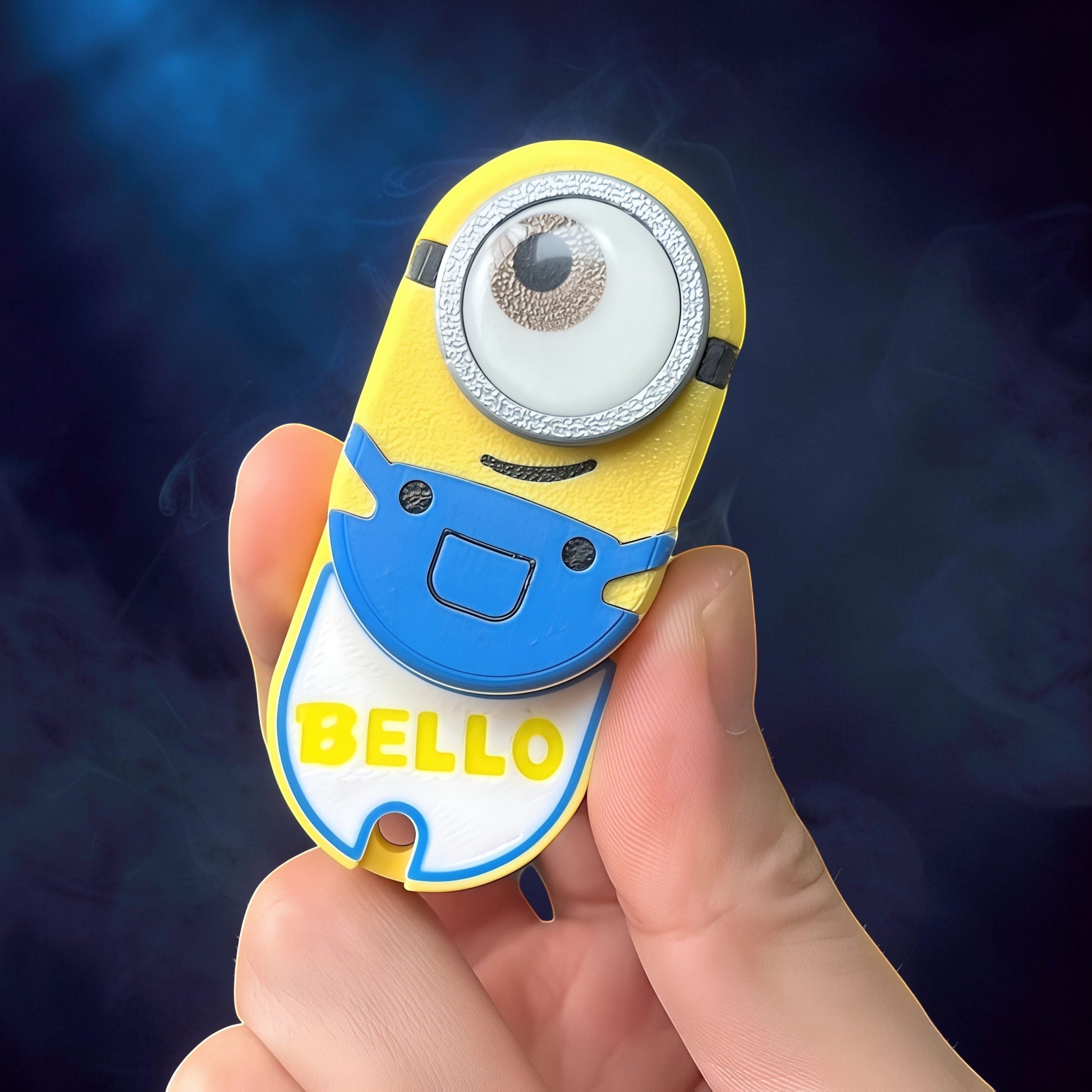 The Curious Mind Minion Pocket Push Pop Clicker fidget toy in yellow and blue with a single eye and