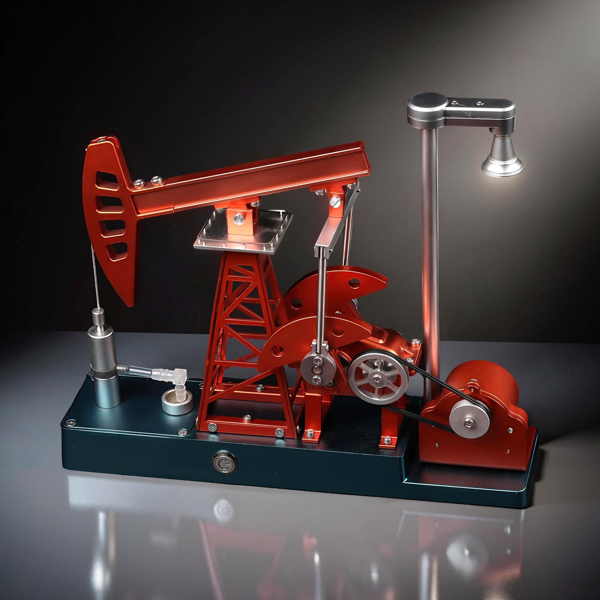 The Curious Mind metal oil derrick pumping unit DIY kit, a detailed mechanical model with red and blue components and a working lamp.
