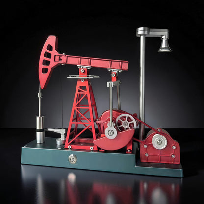 The Curious Mind Oil Derrick Pumping Unit DIY Kit, a detailed metal model with red and teal components, featuring a working mechanism and a small lamp.