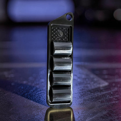 The Curious Mind Pea Pod Pop Coin Clicker, a novelty metal fidget toy with four black pods that click when pressed.