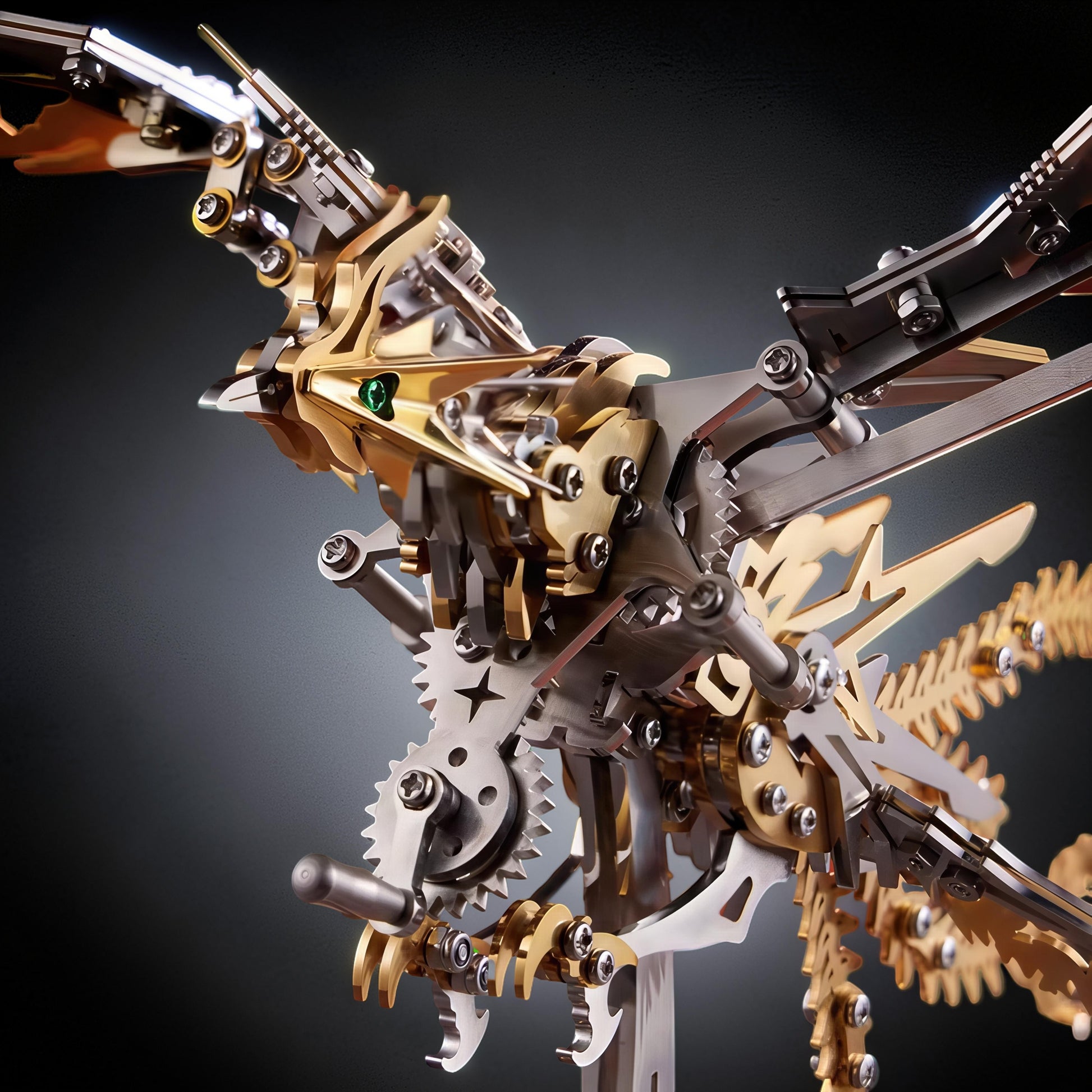 The Curious Mind Phoenix DIY Kit, a mechanical creature model made of silver and gold metal with intricate gears and a green gem eye.
