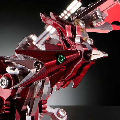 The Curious Mind Phoenix DIY Kit, a metallic mechanical creature model with red and silver parts and green gem eyes.
