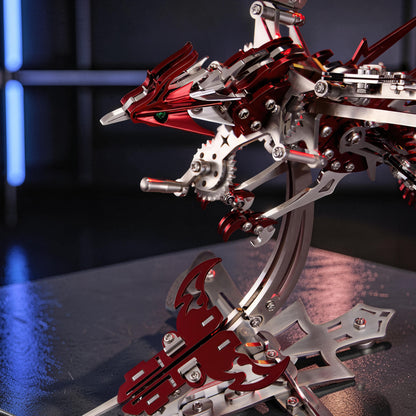 The Curious Mind Phoenix DIY Kit, a mechanical creature model made of silver and red metal with intricate gears and details.