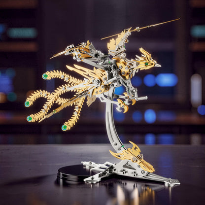 The Curious Mind Phoenix DIY Kit, a silver and gold mechanical creature model made of metal, with intricate details and green accents.