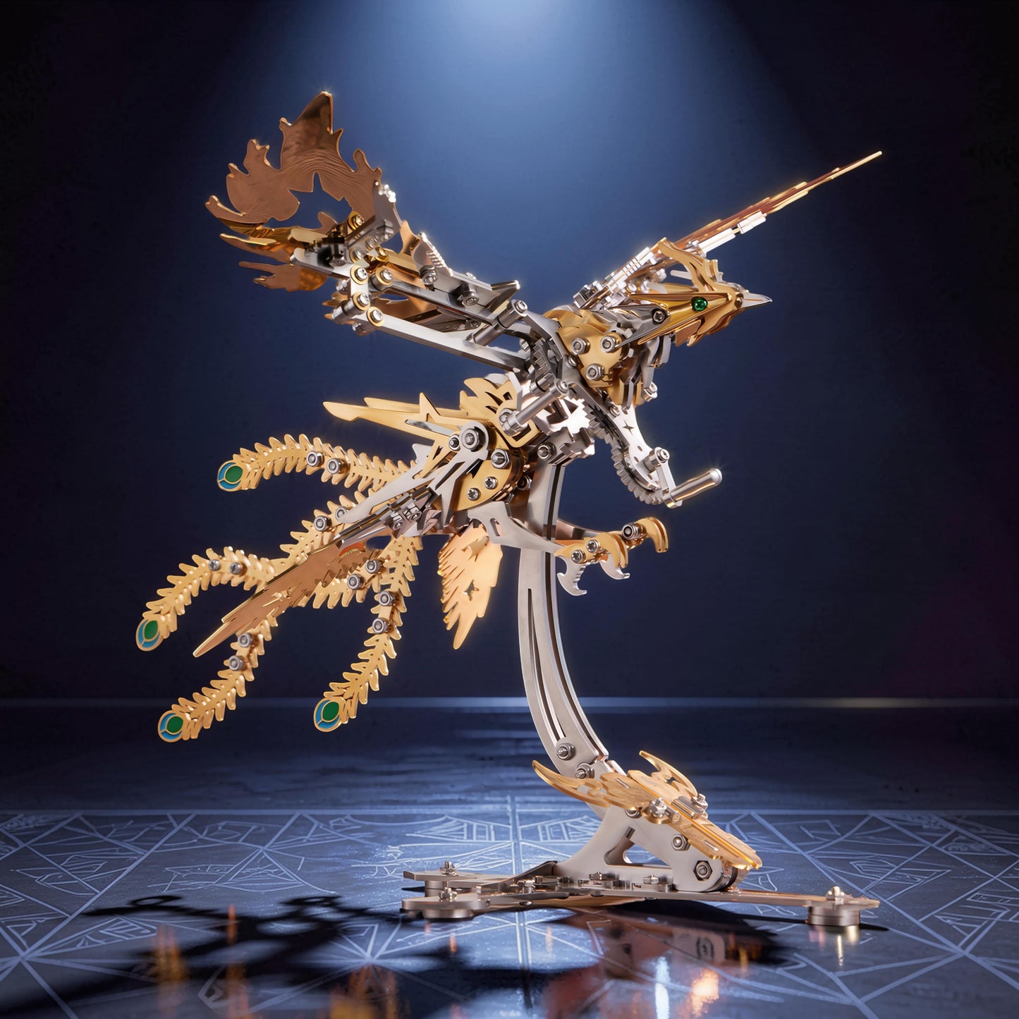 The Curious Mind Phoenix DIY Kit, a mechanical creature model made of silver and gold metal with green gem accents.