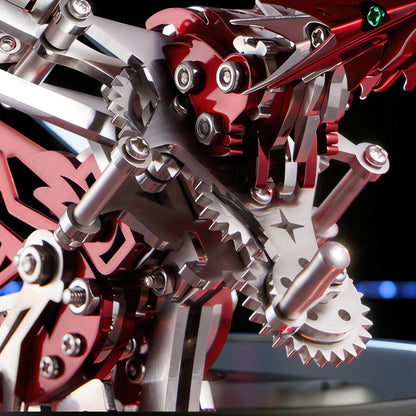 The Curious Mind Phoenix DIY Kit, a mechanical creature model made of silver and red metal, featuring intricate gears and a detailed head with a green eye.