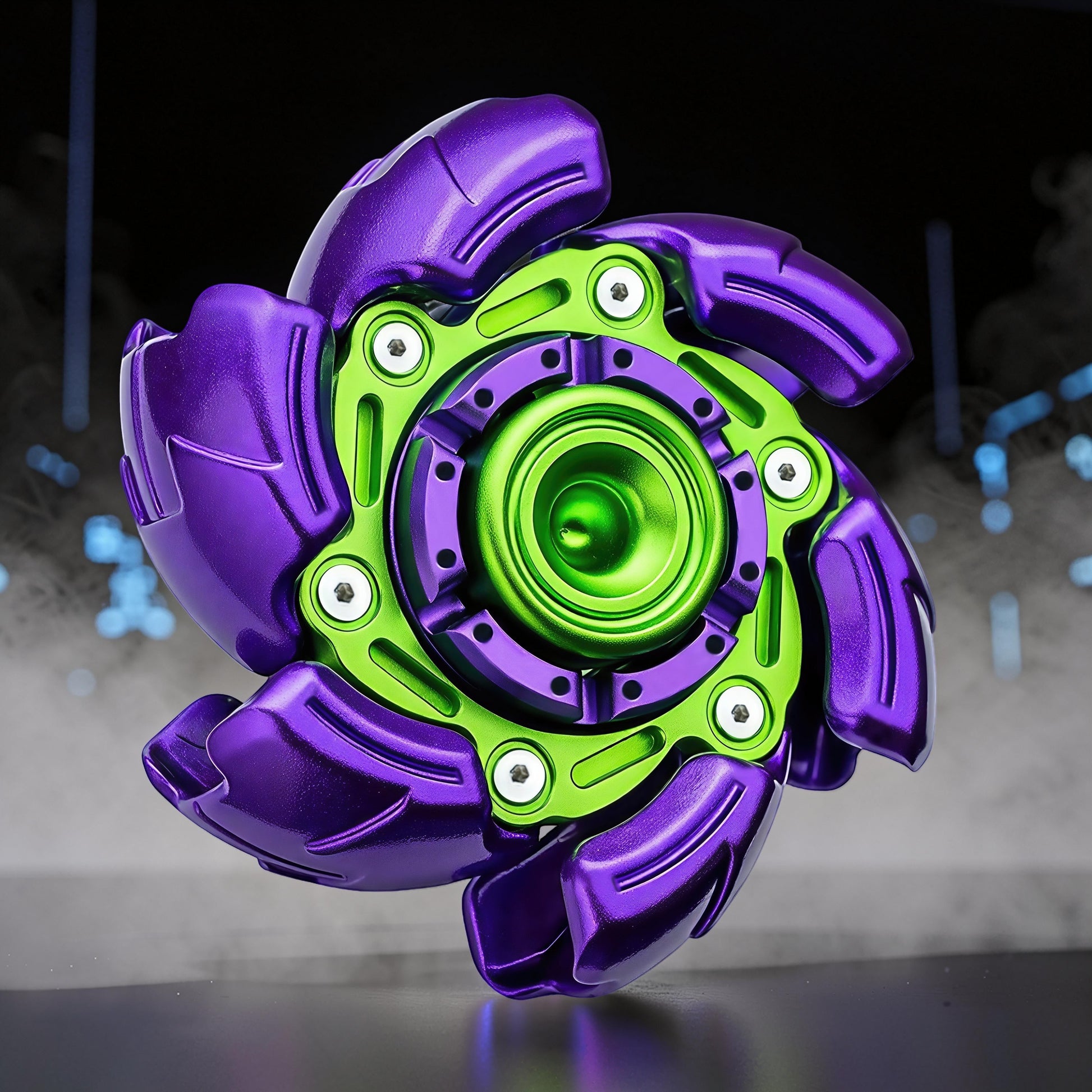 The Curious Mind Open Armour Hand Spinner: a metallic purple and green fidget spinner with intricate detailing and a central bearing.