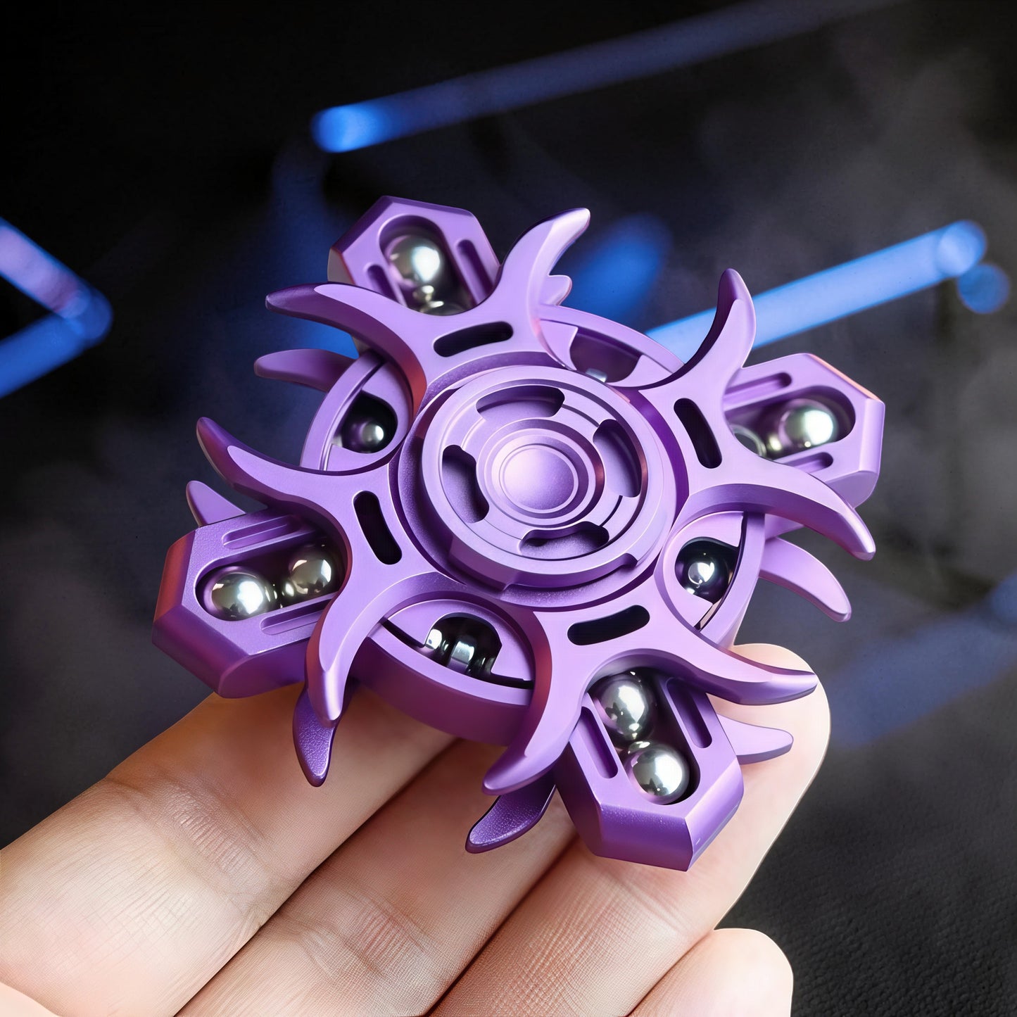 The Curious Mind Oracle Metal EDC Fidget Spinner in purple, featuring a unique starburst design with silver bearings. Held in a hand.