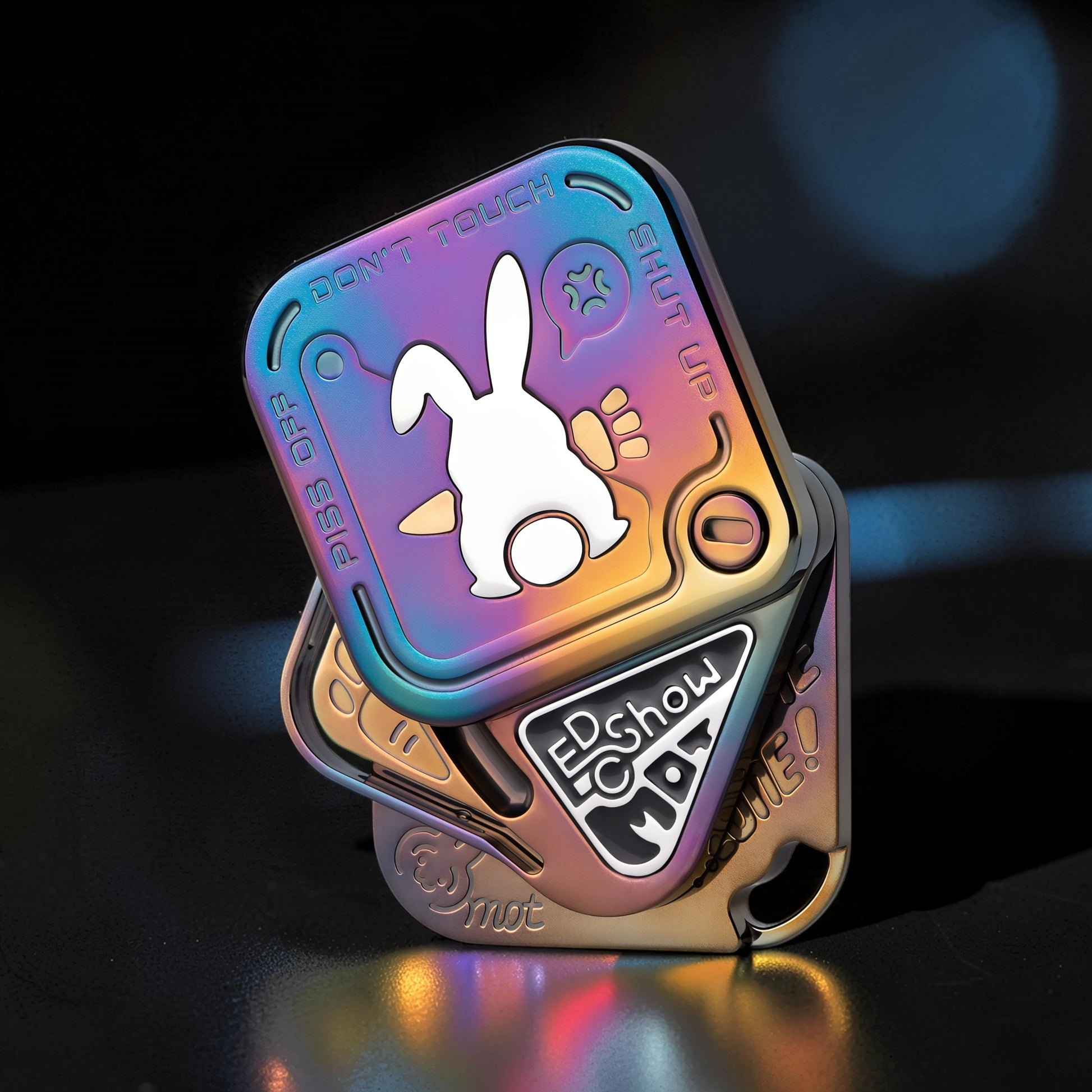 The Curious Mind Rabbit Tuning Fork Clicker fidget toy with a white rabbit graphic and iridescent metal finish.