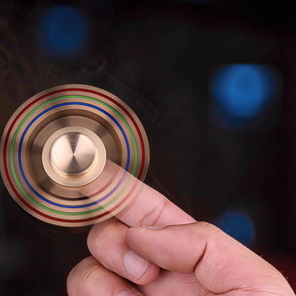 The Curious Mind Rainbow Metal Hand Spinner with red, green, and blue accents. Premium EDC fidget toy.