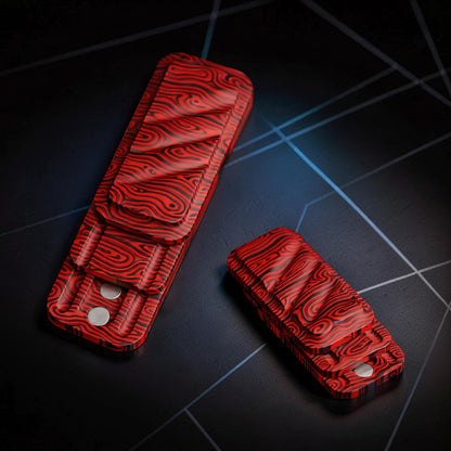The Curious Mind Three-Layer Push Card Slider fidget toy in red and black Damascus pattern metal.