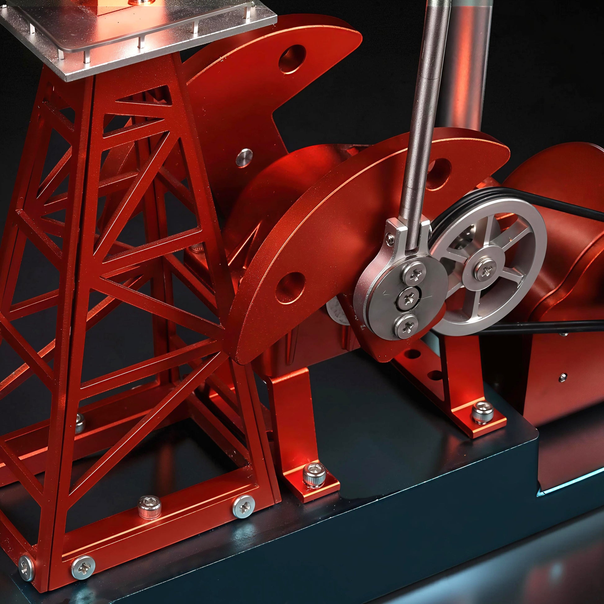 The Curious Mind red metal oil derrick pumping unit DIY mechanical model kit with intricate details and a pulley system.