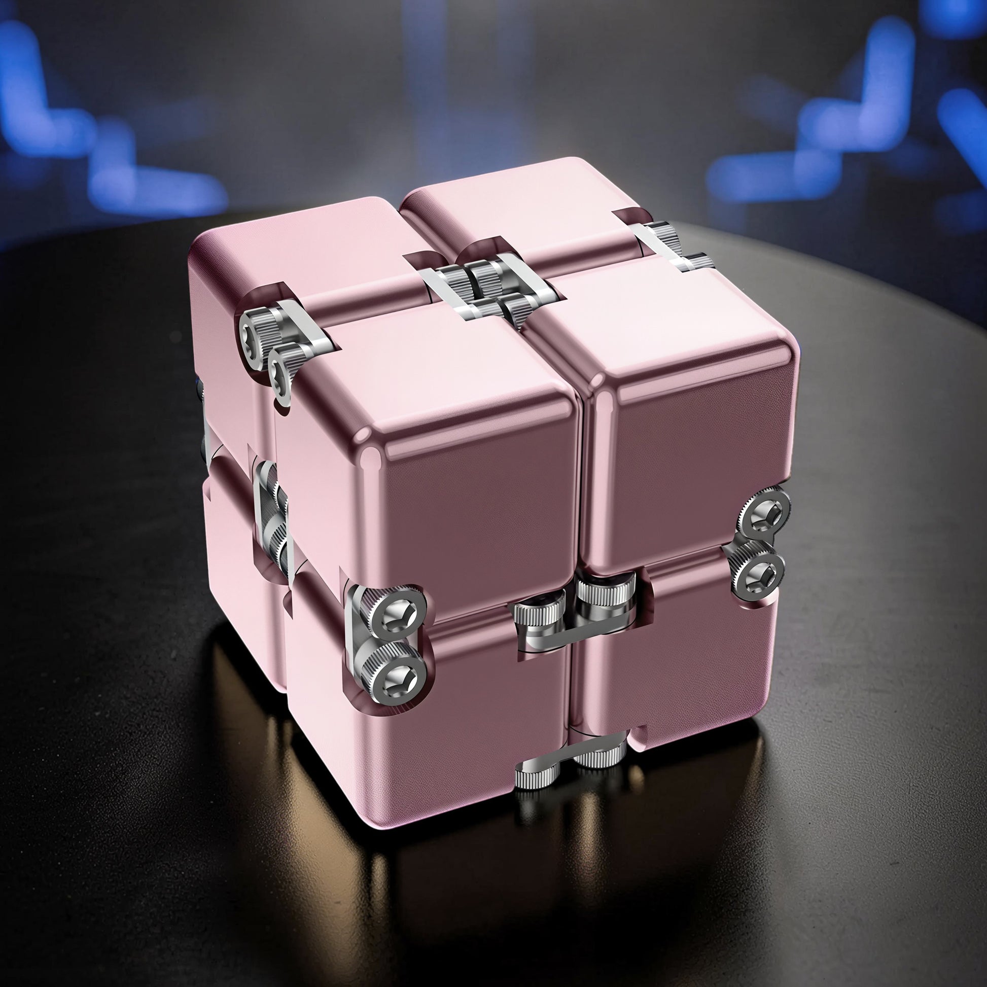 The Curious Mind Unlimited Magic Fidget Cube in rose gold metal with a compact, transforming design. Features visible screws and hinges for satisfying tactile play.