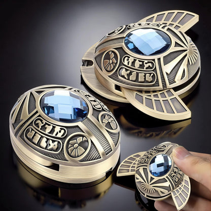 The Curious Mind Scarab Metal EDC Fidget Spinner with blue gem and Egyptian hieroglyphs.
