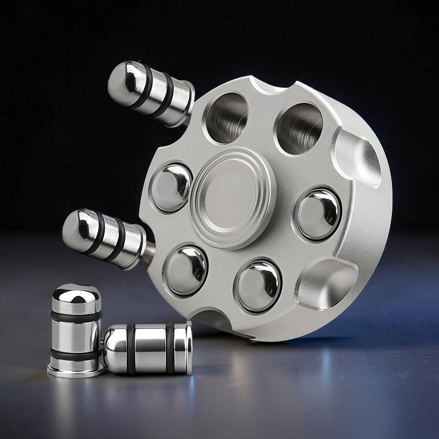 The Curious Mind silver brass finger gyro spinner with a revolver cylinder design, featuring six weighted ends and a central bearing.