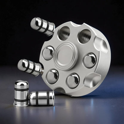 The Curious Mind silver brass finger gyro spinner with a revolver cylinder design, featuring six weighted ends and a central bearing.