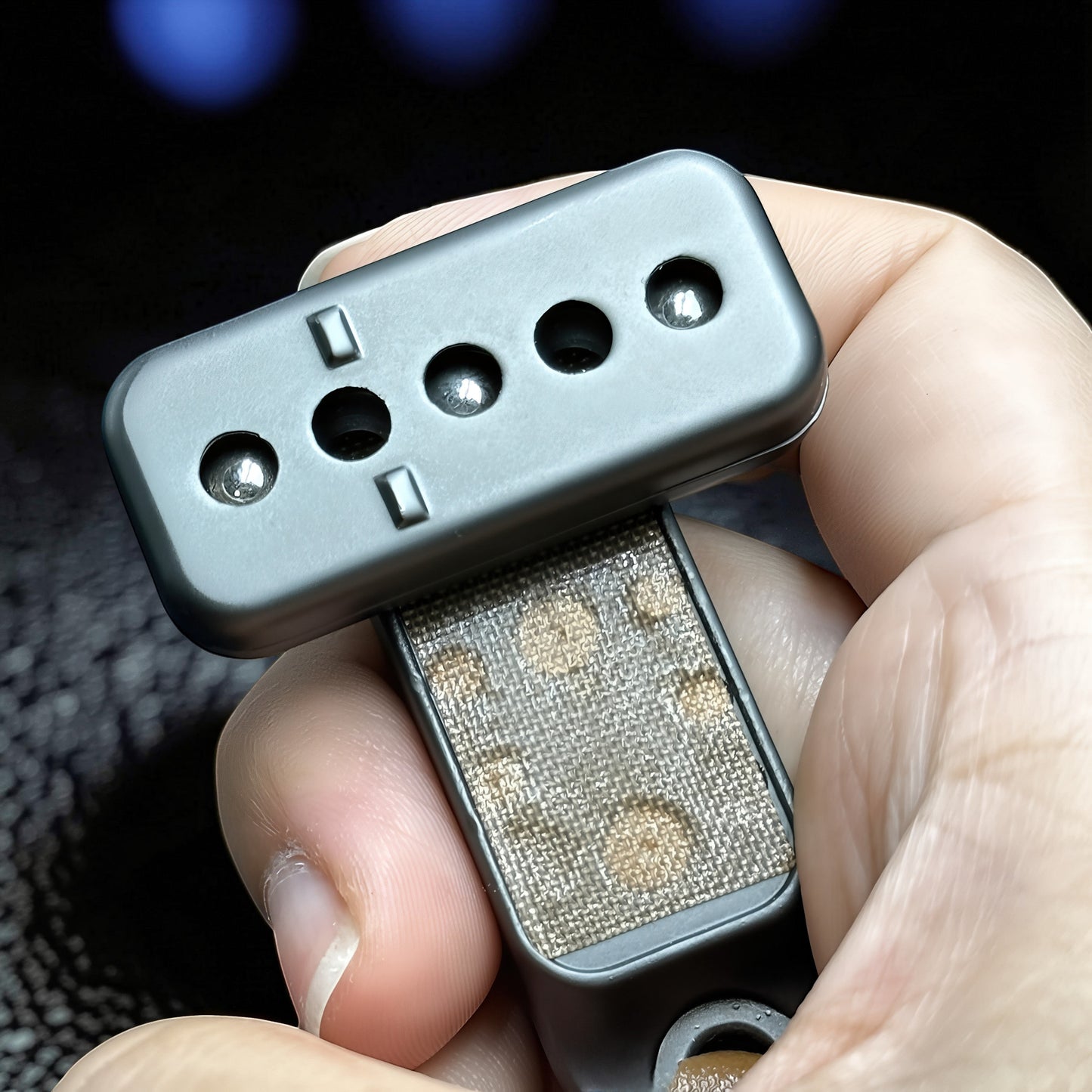 The Curious Mind Silver Buckle Card Slider fidget toy made of zinc alloy with a push-and-return motion.