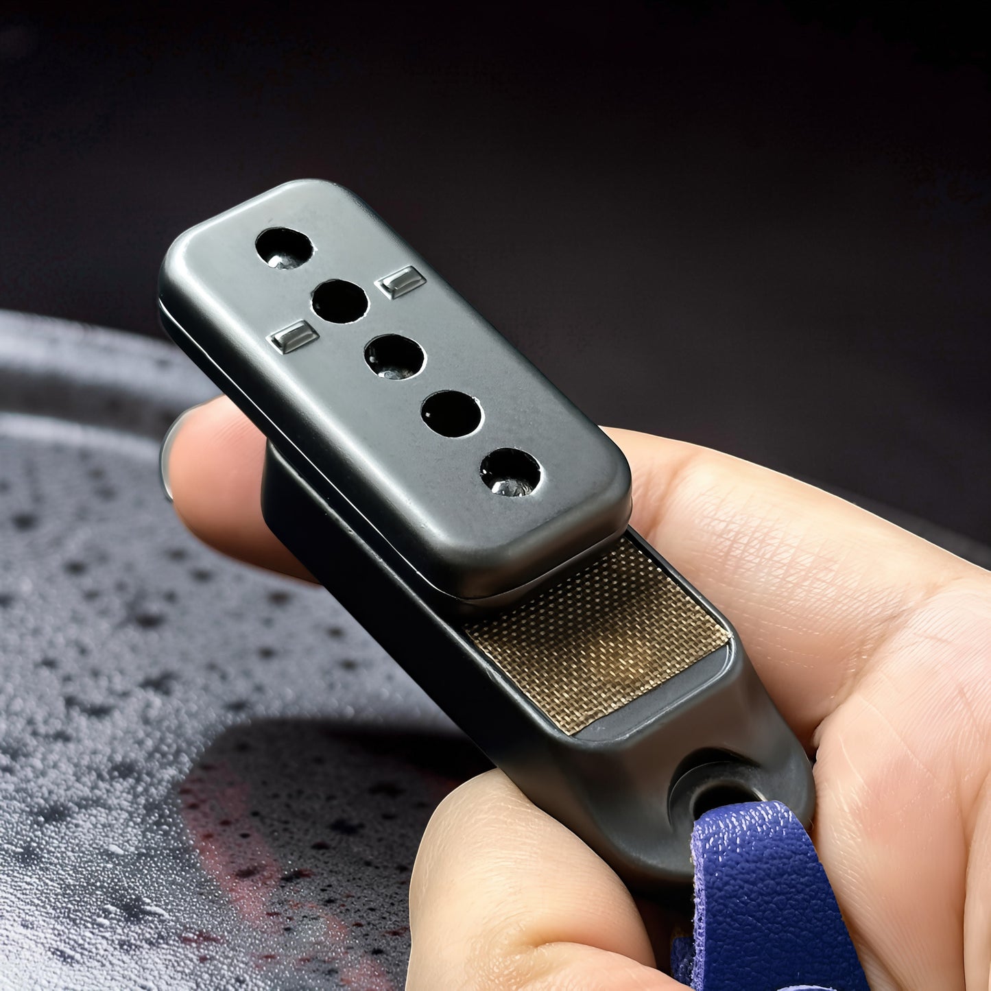 The Curious Mind Silver Buckle Card Slider fidget toy with blue leather loop, made of metal.