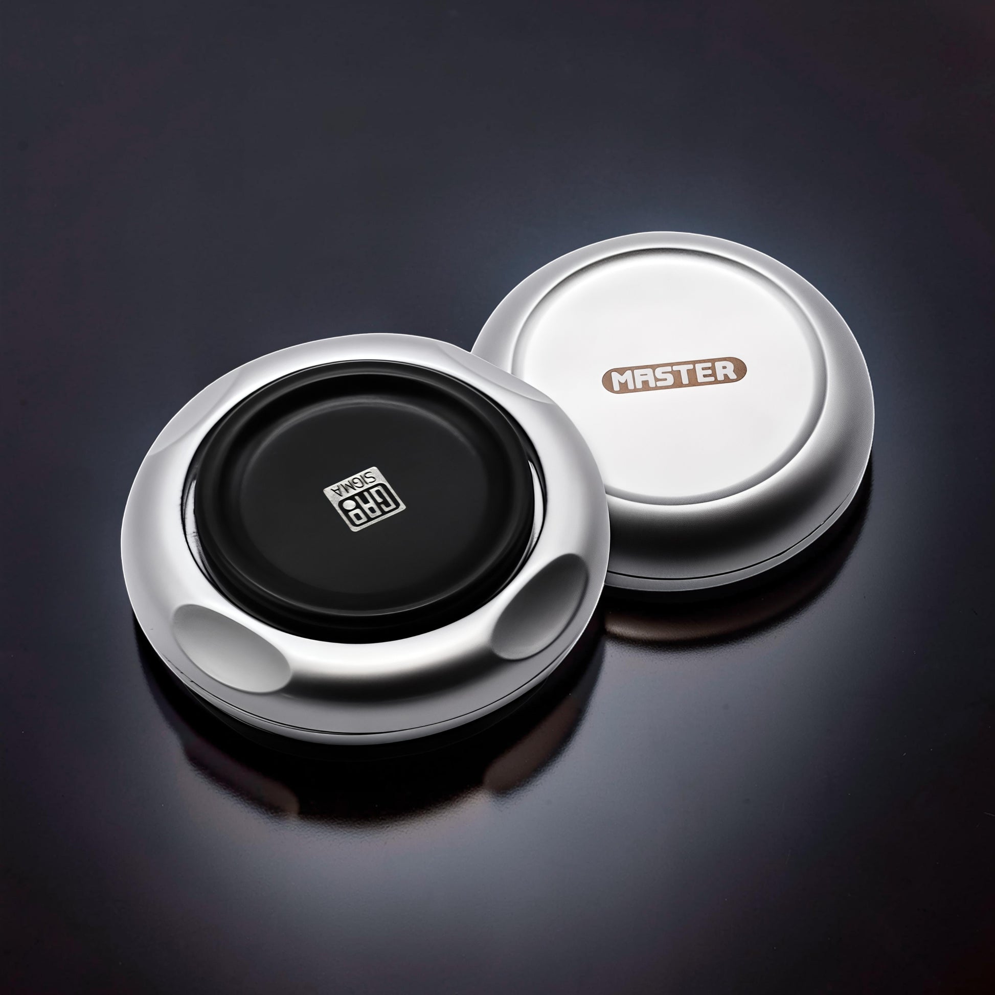 The Curious Mind Magnetic Master 2.0 spinner, silver metal with black center and magnetic accents. EDC fidget toy.