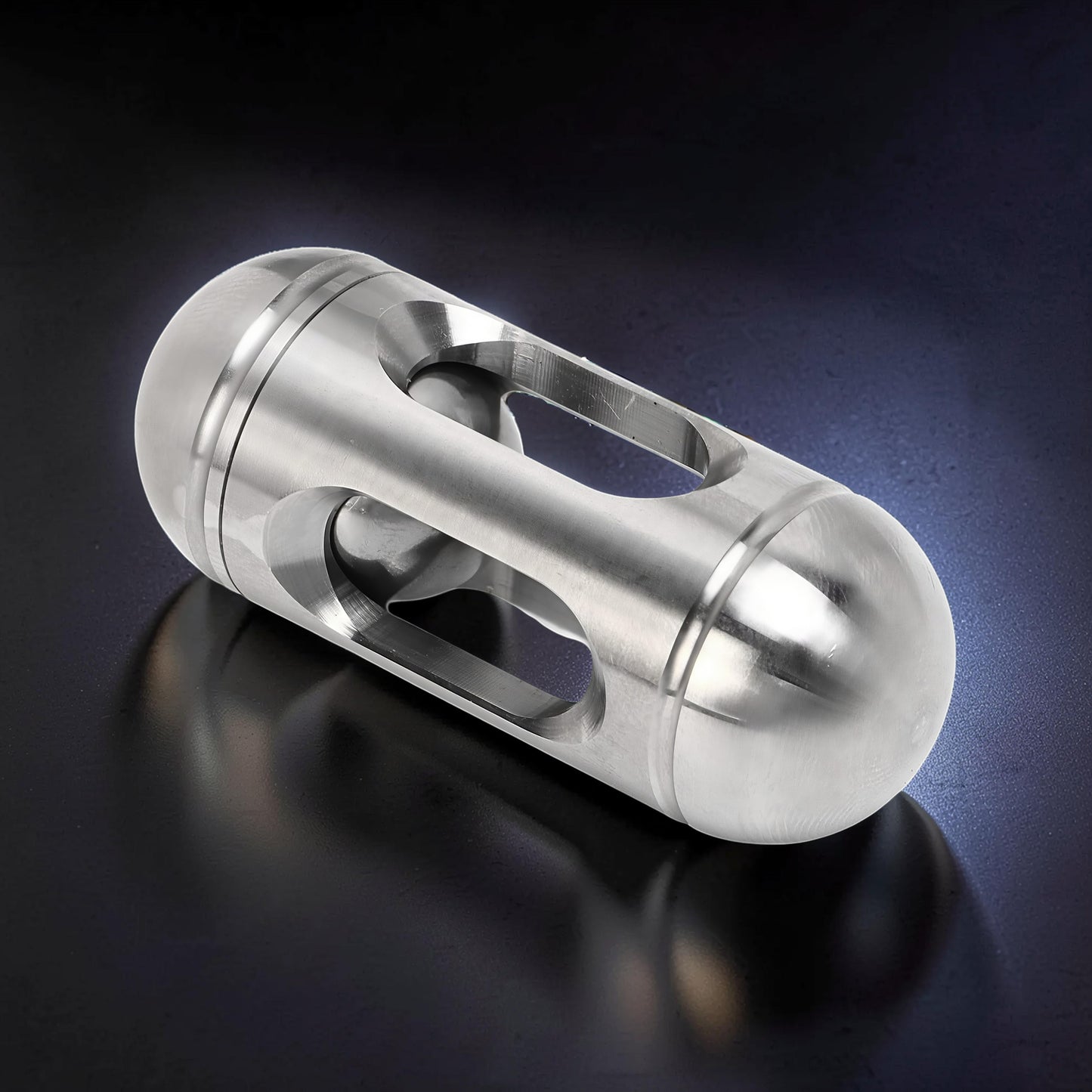 The Curious Mind silver metal egg-shaped pocket spinner with cutouts for smooth rotation. Compact and durable fidget toy.