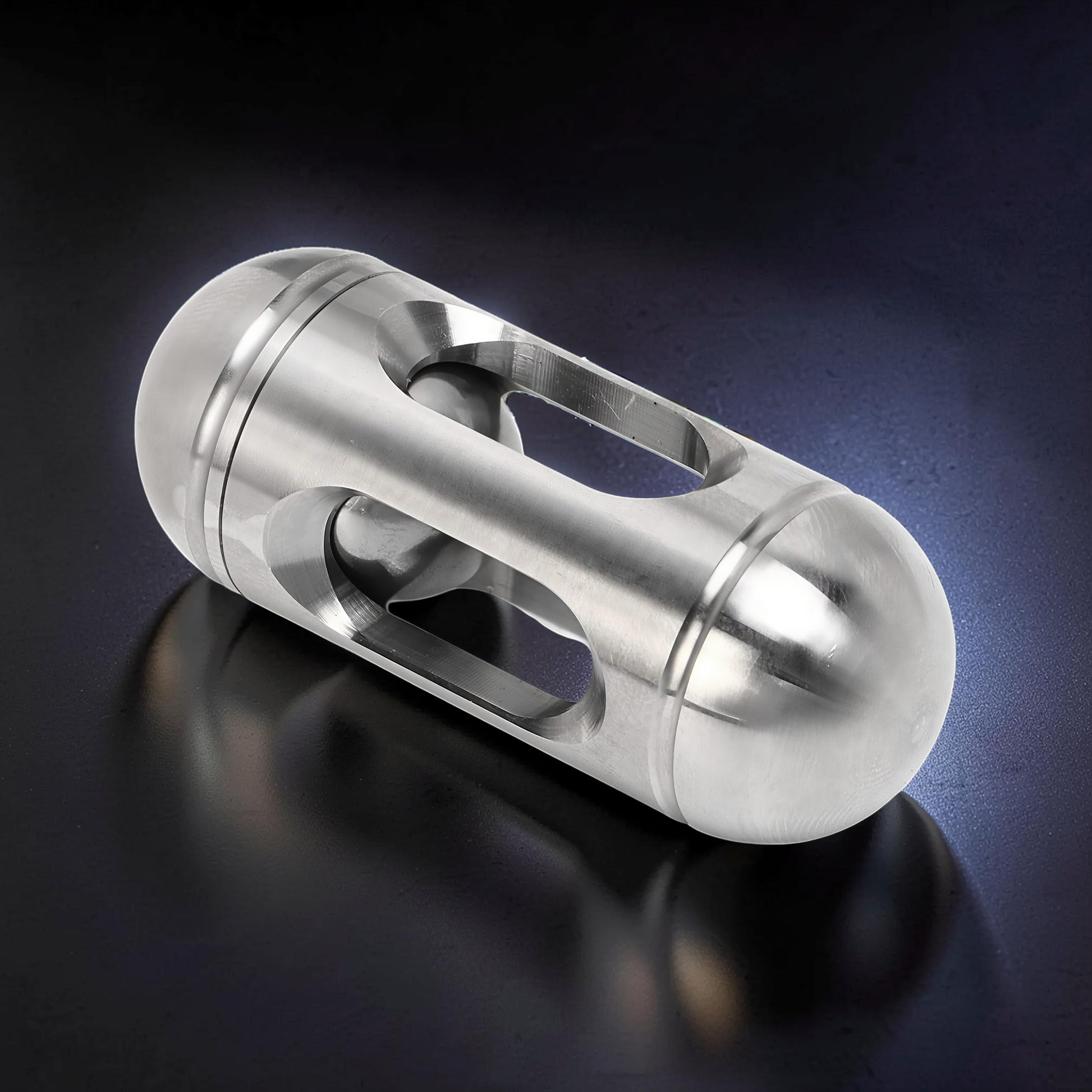The Curious Mind silver metal egg-shaped pocket spinner with cutouts for smooth rotation. Compact and durable fidget toy.