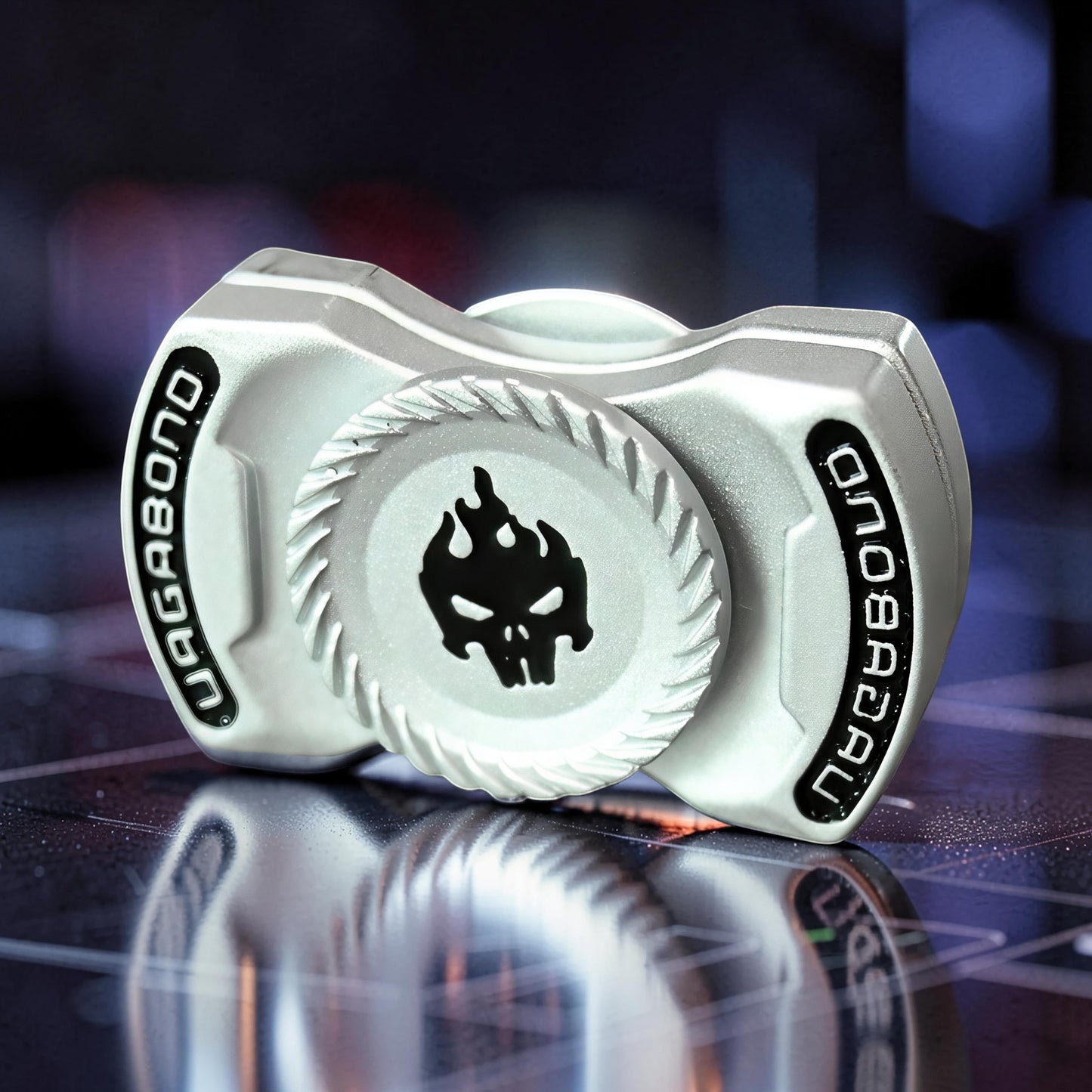 The Curious Mind Butterfly Plus metal spinner in silver with a black flame skull design. Features 'VAGABOND' text.