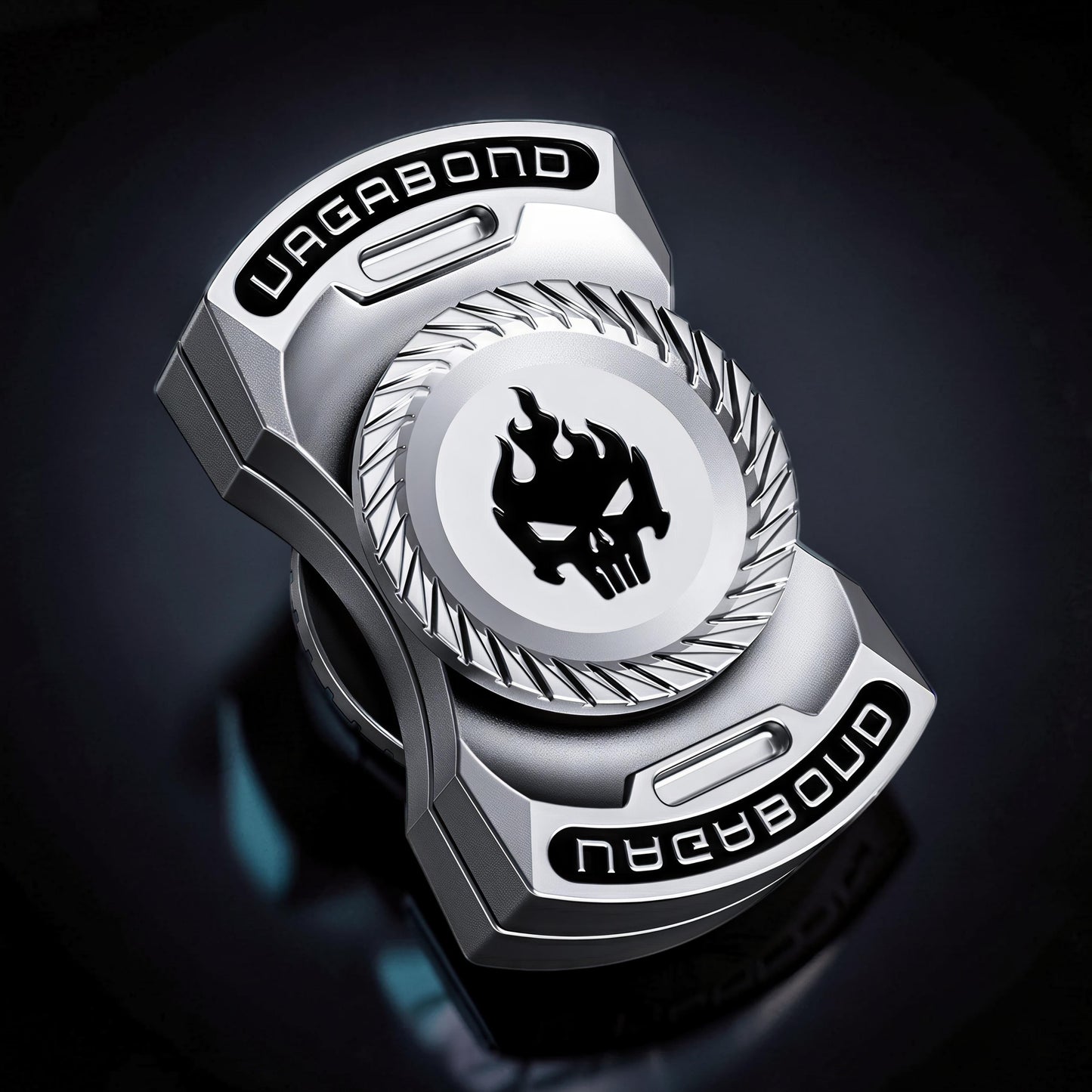 The Curious Mind silver metal spinner with black skull and flames logo, 'VAGABOND' text.