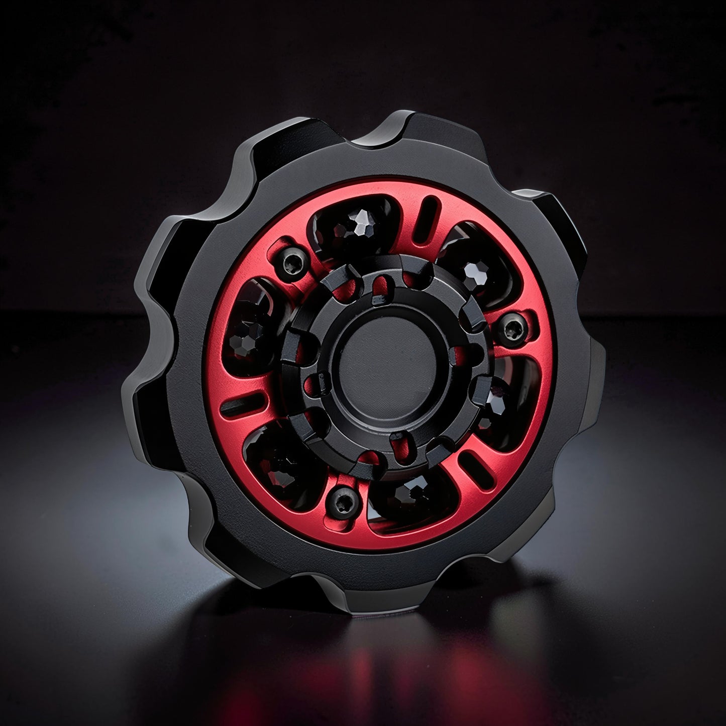 The Curious Mind Six-Bead Gear Spinner: black metal fidget toy with red gear-style accents and six beads.