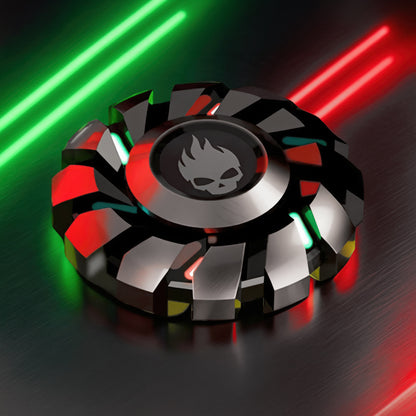 The Curious Mind Skull Wheel Glow Spinner, a metal fidget toy with turbine-style design, skull emblem, and red/green glowing accents.