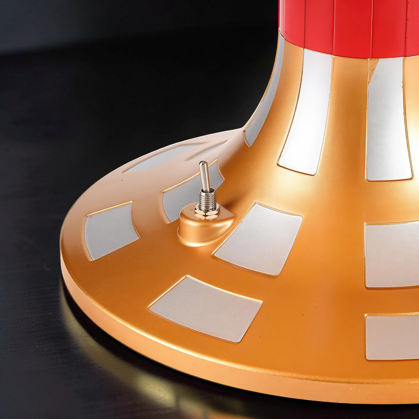 The Curious Mind Solar System DIY Kit base with gold finish, silver accents, and a silver toggle switch.